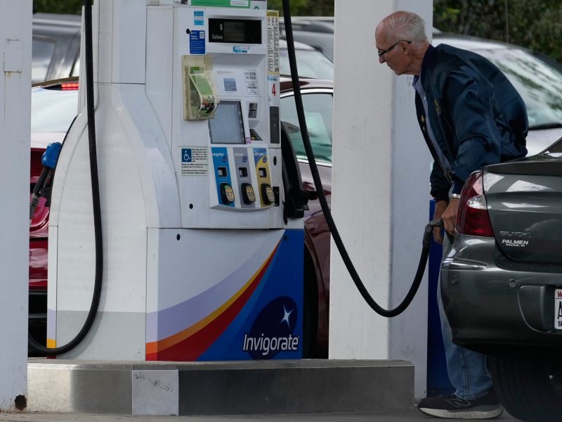 A customer checks gas price while he fills up his vehicle's tank at a gas station Tuesday, Sept. 22, 2026.