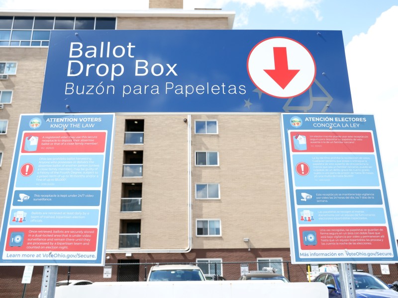 The signs above a ballot drop box.